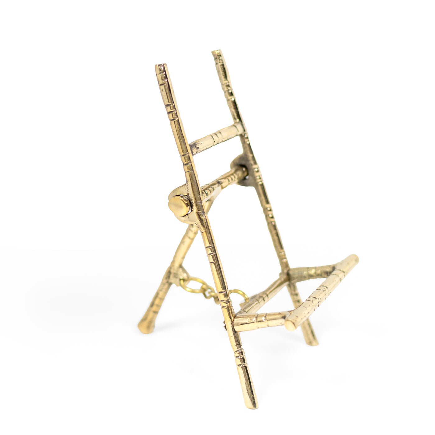 3/4 profile view of a brass faux bamboo mini easel to display art.