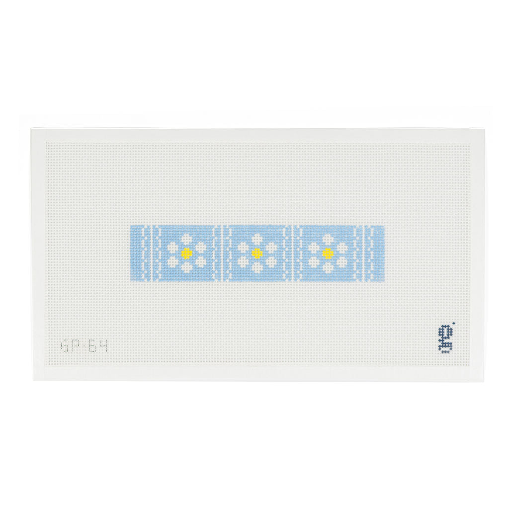 White needlepoint canvas featuring long light blue rectangular design with white and yellow daisies divided by vertical white scalloped stripes.