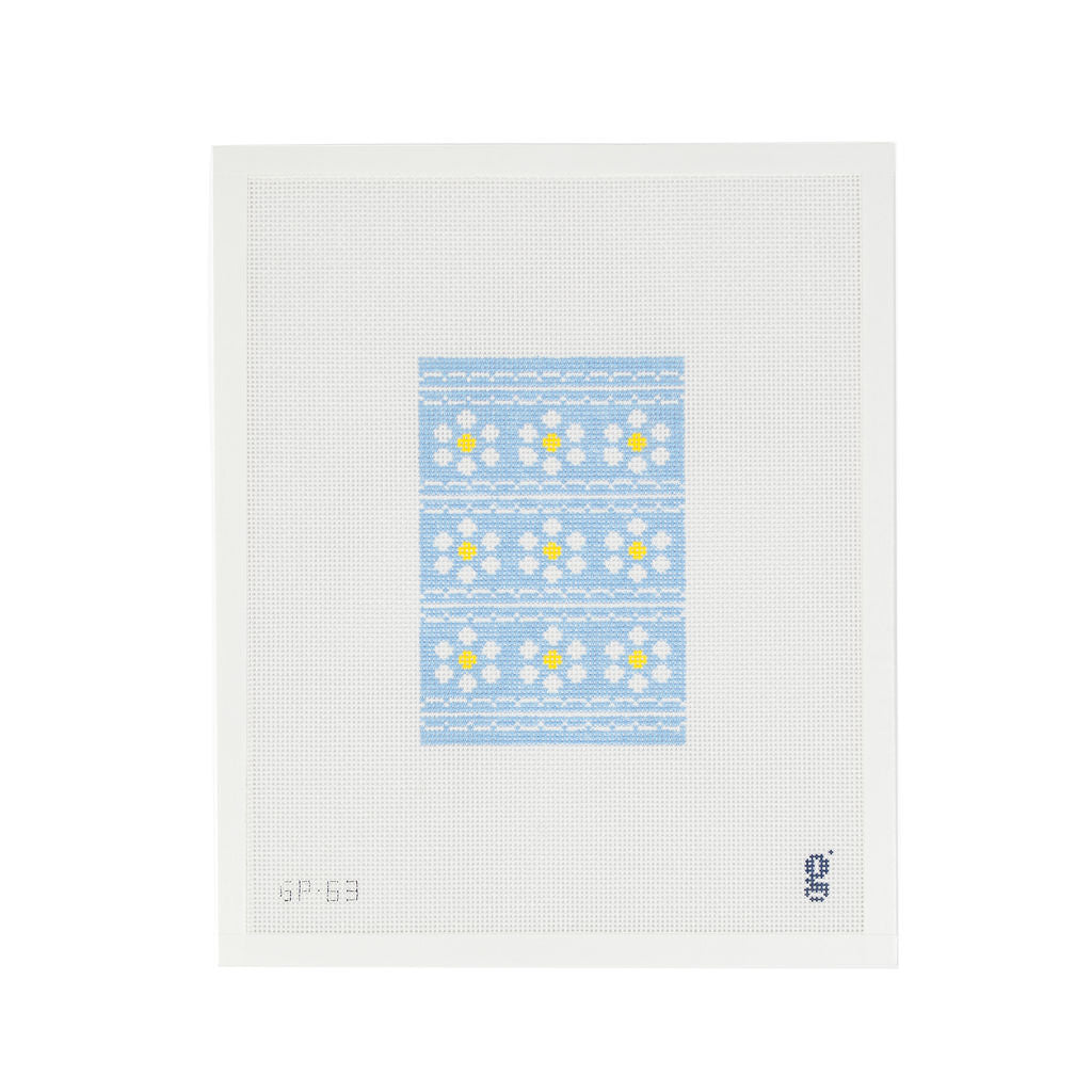 White rectangular needlepoint canvas featuring light blue rectangular design of white and yellow daisies in horizontal rows divided by white scalloped stripes.