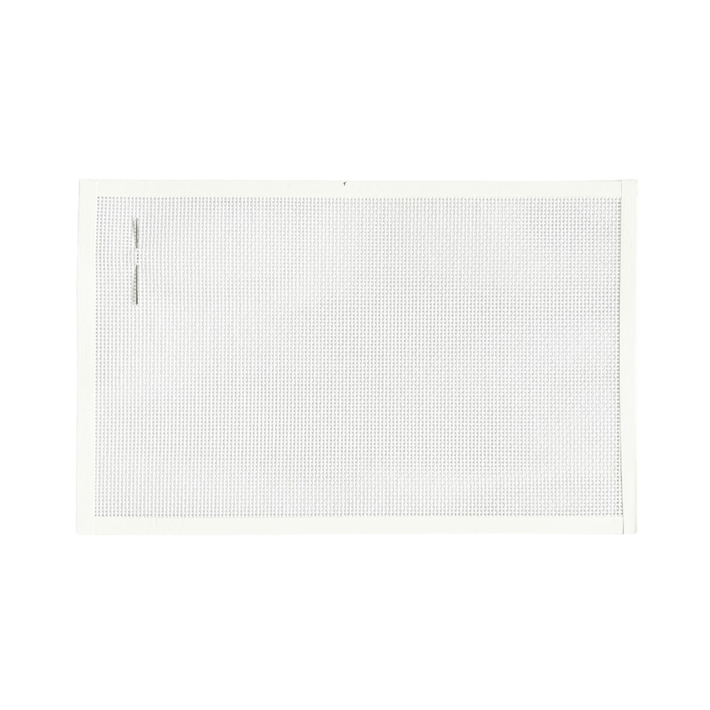Blank piece of white 13 mesh mono needlepoint canvas with white binding tape and a tapestry needle on the left side of the canvas