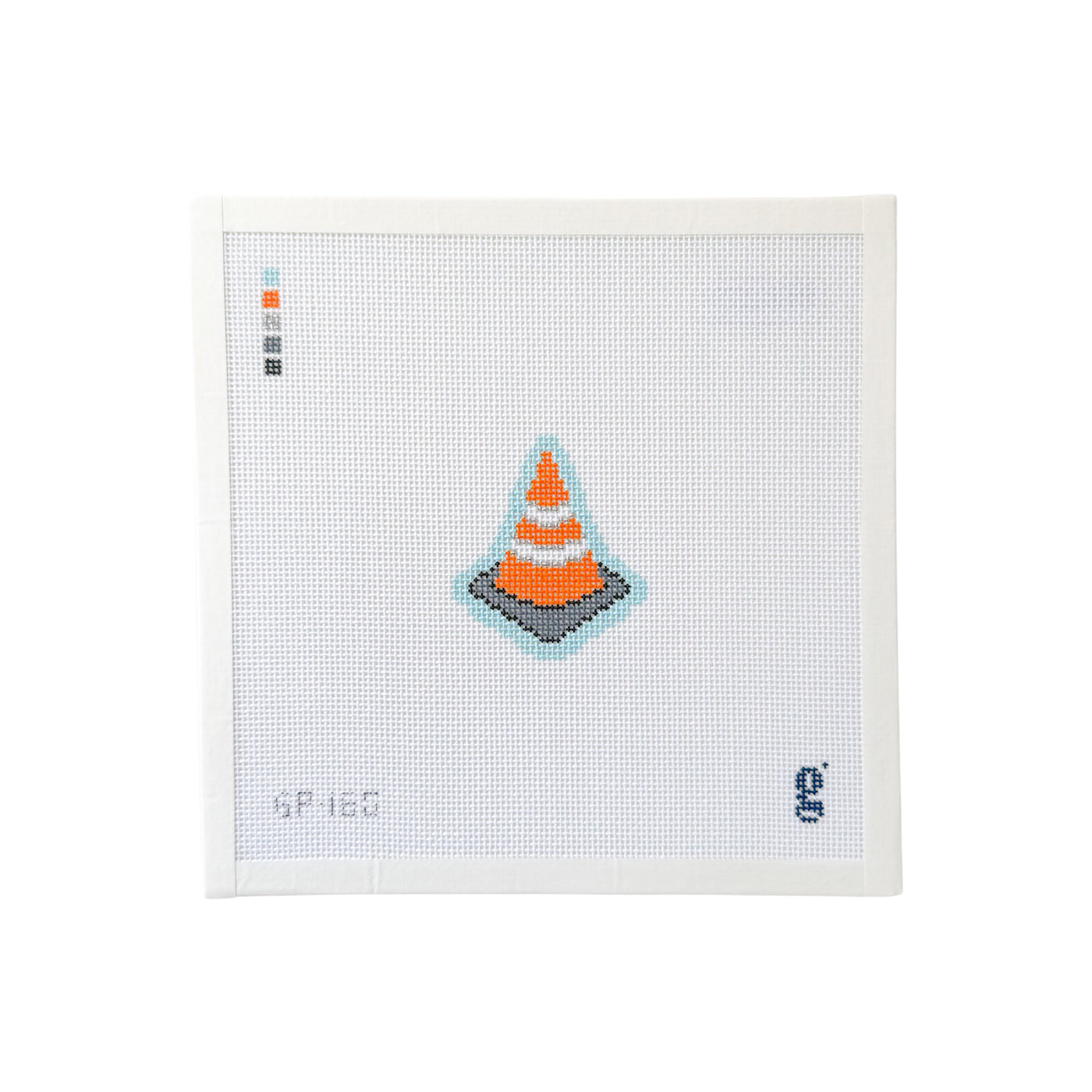 white square shaped needlepoint canvas with illustration of an orange construction cone at center