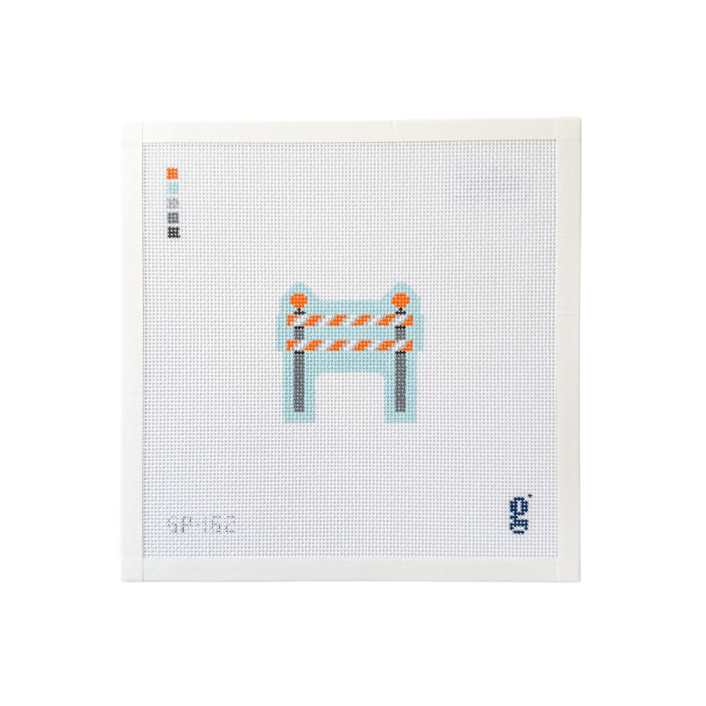 white square shaped needlepoint canvas with illustration of a construction double barricade at center