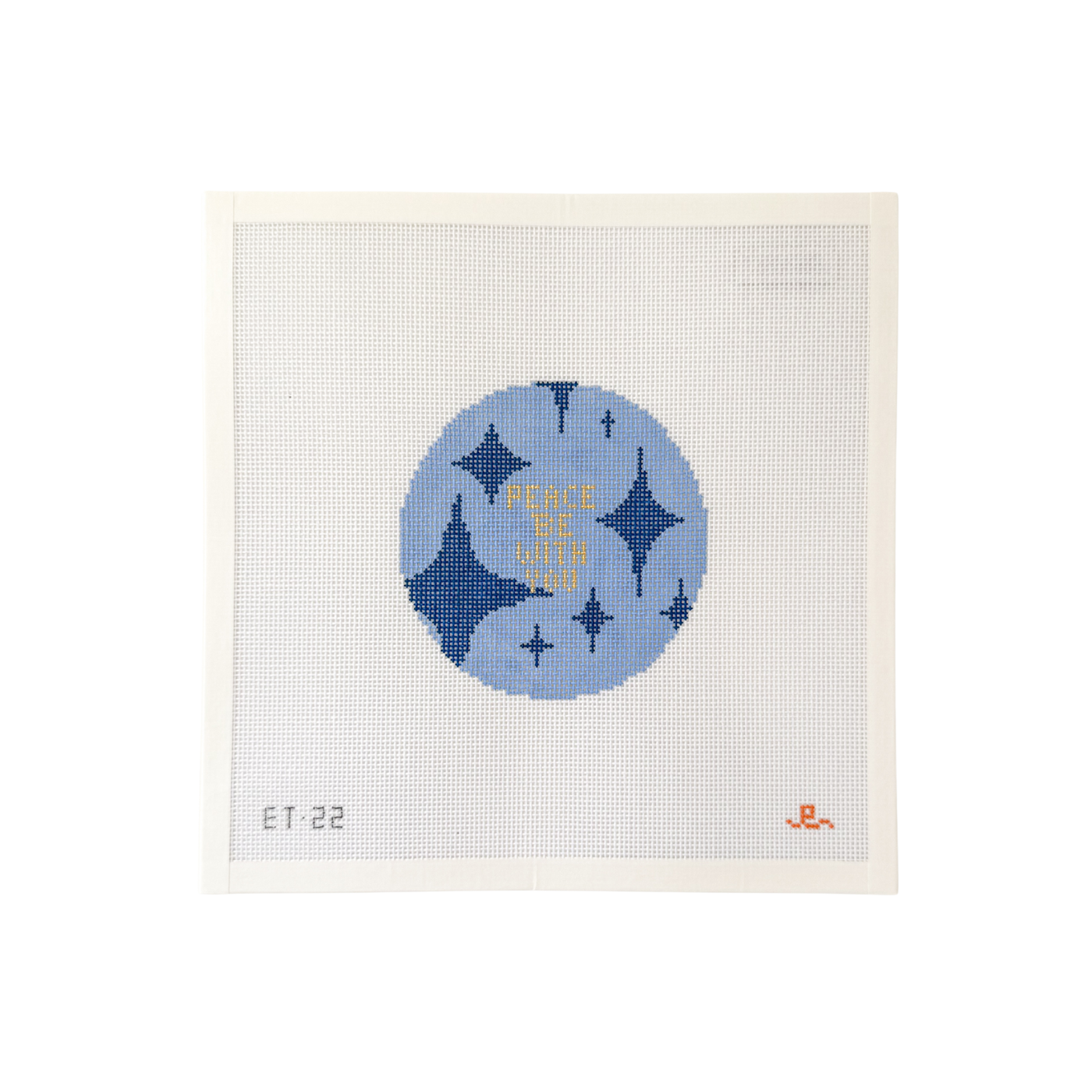 White square shaped needlepoint canvas with blue circular design with dark blue diamonds and the words "PEACE BE WITH YOU" in gold text