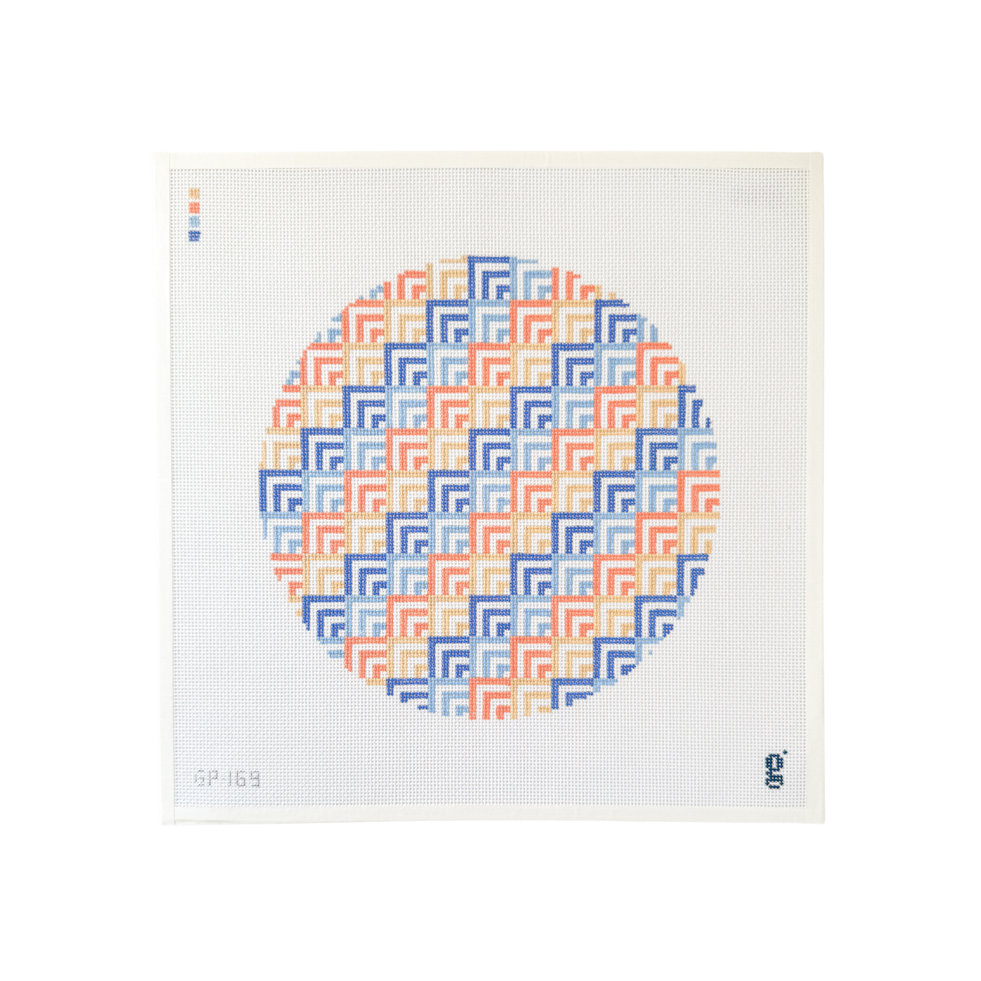 white square shaped needlepoint canvas with large circular design with coral, periwinkle and sand colored geometric pattern