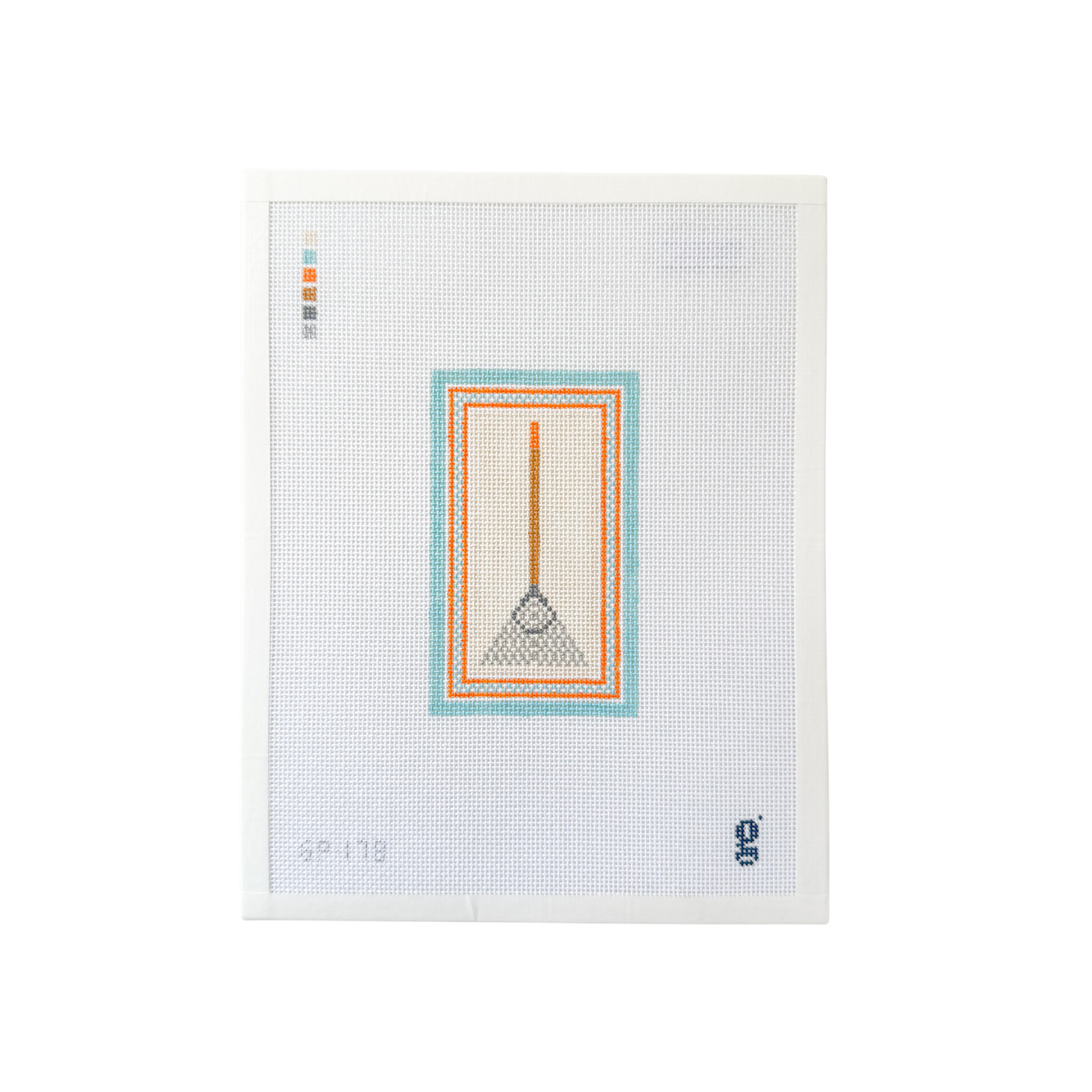 white rectangle needlepoint canvas with tan and silver garden rake at center surrounded by aqua and orange patterned border