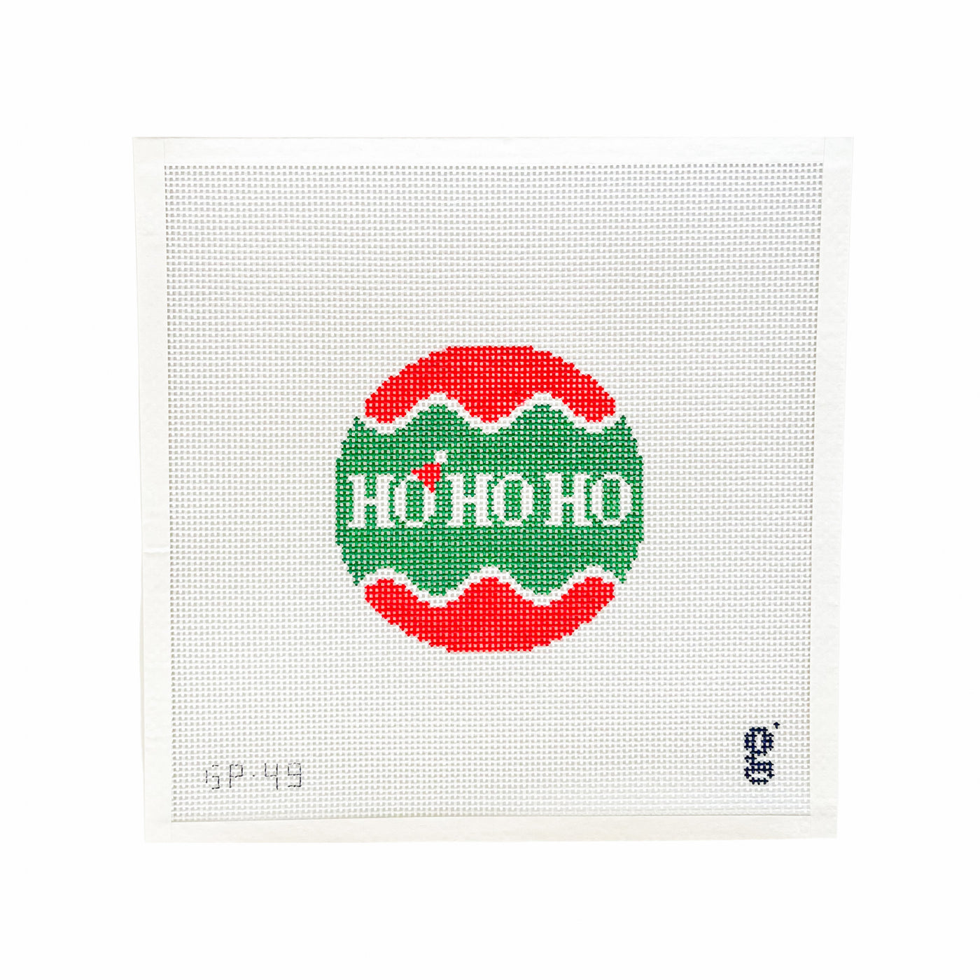 White square shaped needlepoint canvas with a circular green and red design at center. The words "HO HO HO" are at center in white. A red santa hat sits on top of the first "O". 