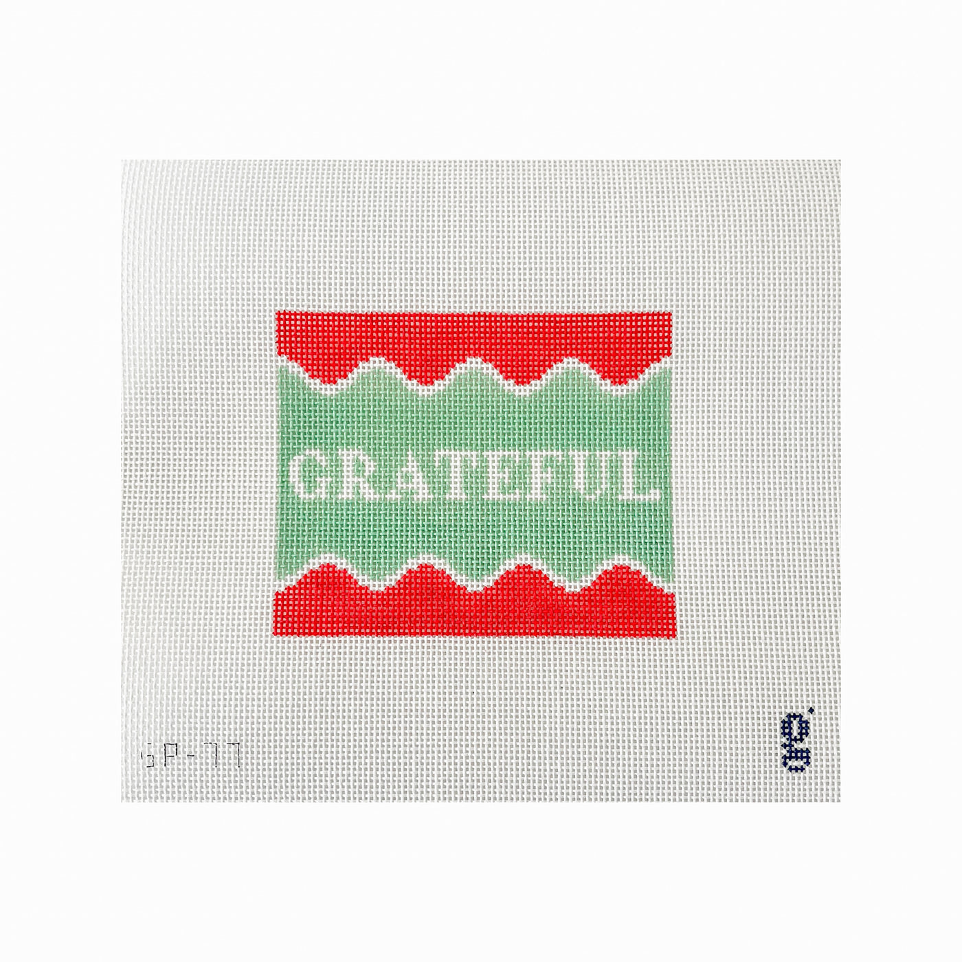 White needlepoint canvas with red, white and mint green design with the word GRATEFUL at center in white