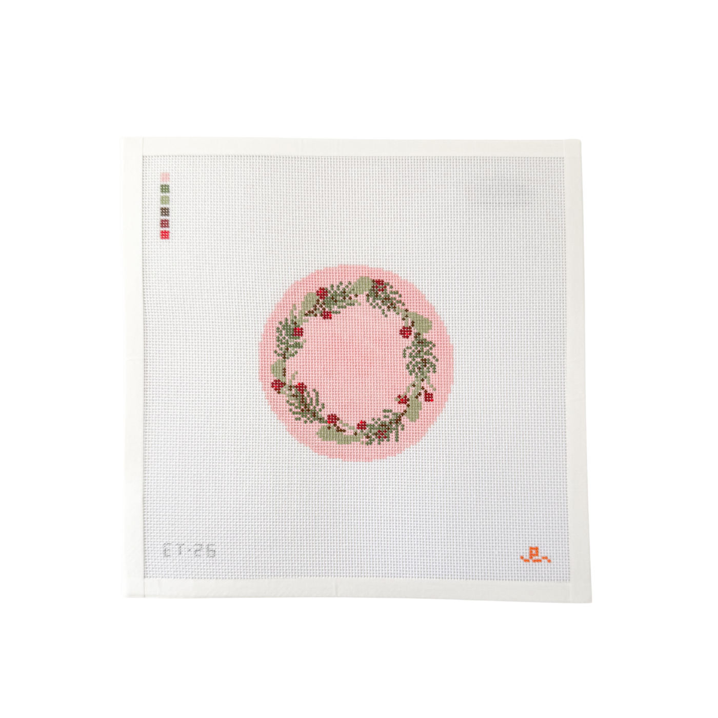 White square needlepoint canvas with pink round design featuring a wreath of holly and other winter flowers 