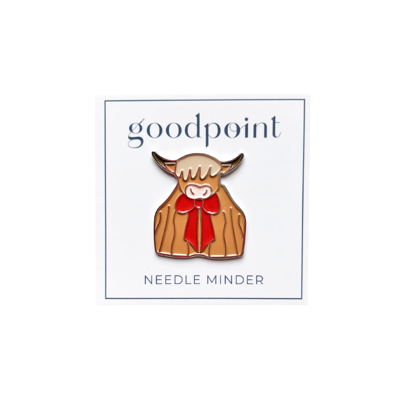 white card stock with the goodpoint logo holds an enamel needle minder shaped like a Highland Cow wearing a red bow