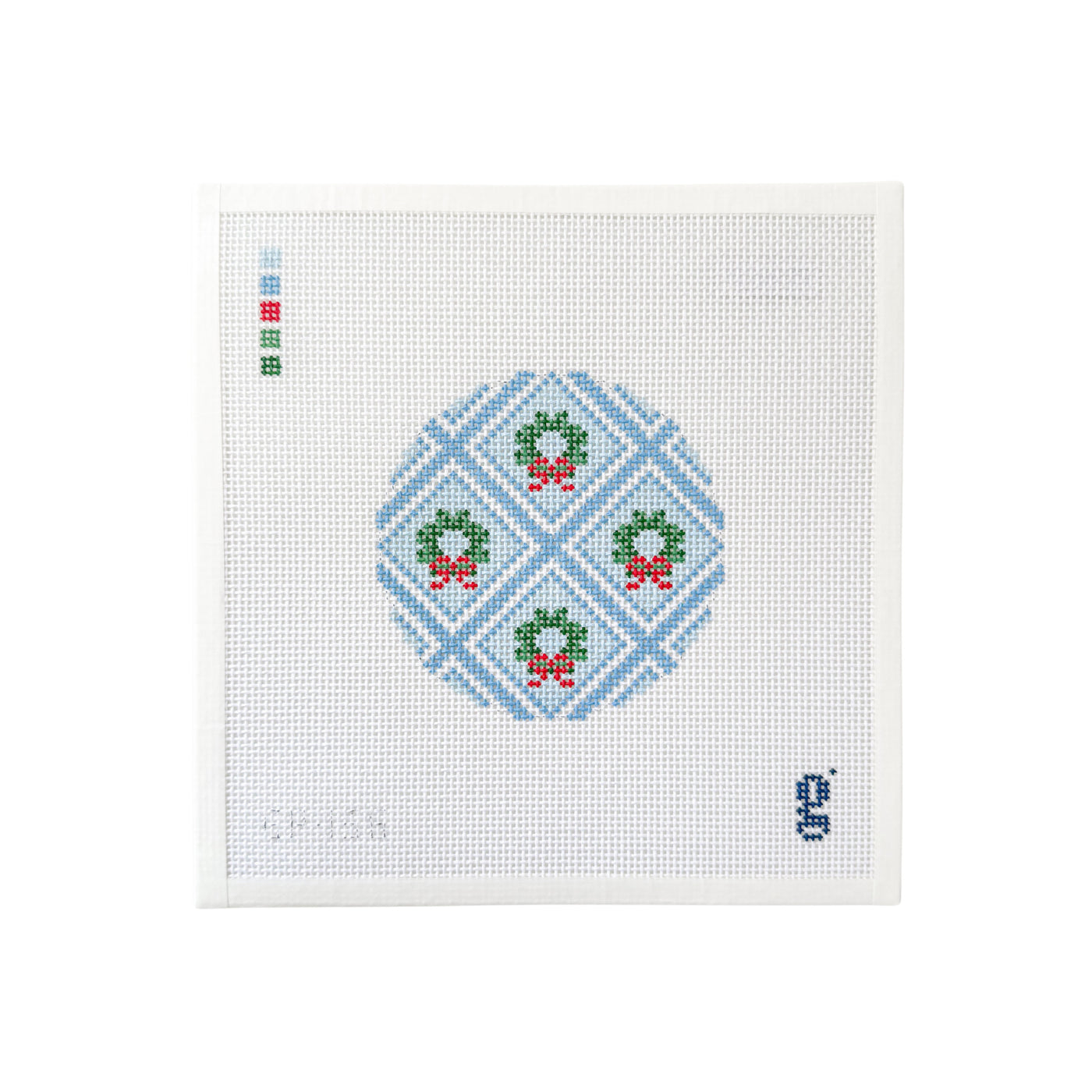 white square shaped needlepoint canvas with light blue round trellis design with green wreaths at center of each trellis
