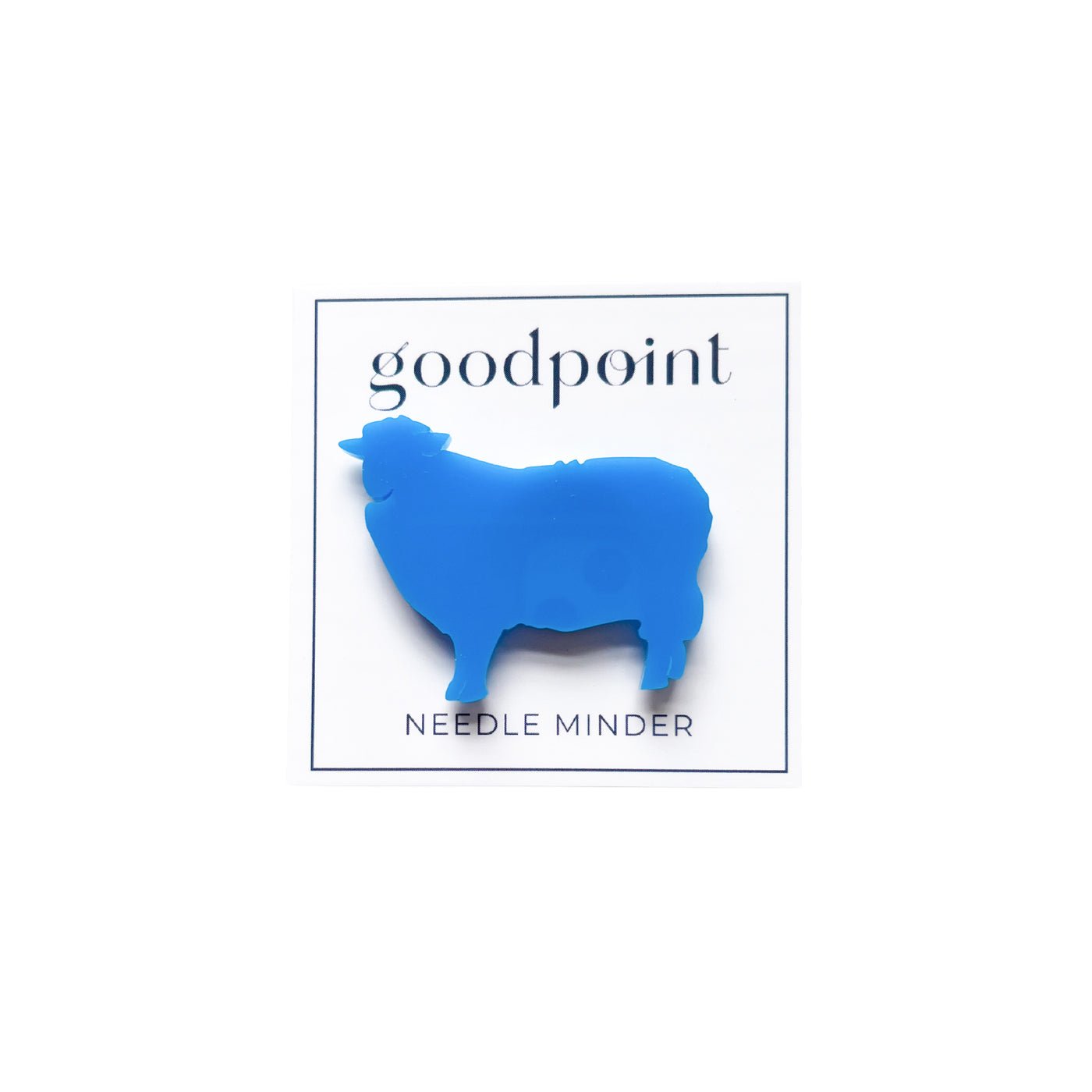 White card stock with the Goodpoint logo holds a blue acrylic needle minder shaped like a sheep