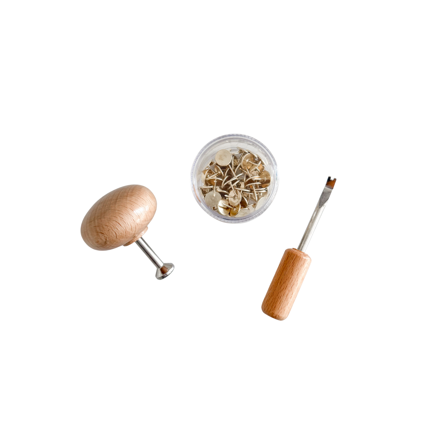 A circular box of steel tacks, a wooden handled extractor tool and a wooden handle magnetic pusher tool