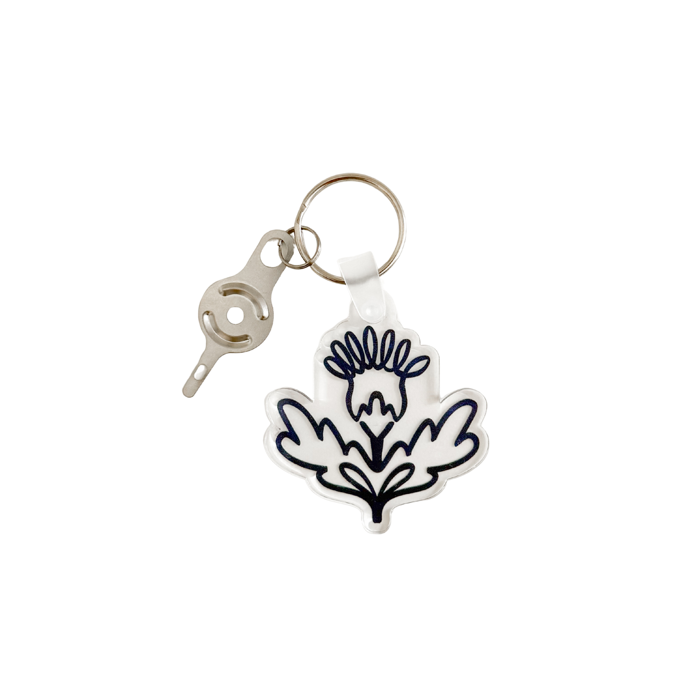 silver needle threader attached to key ring with acrylic navy blue thistle design