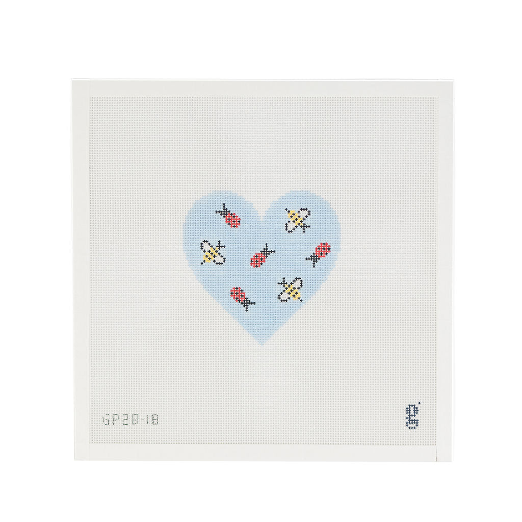 White square shaped needlepoint canvas with a light blue heart at center. Within the heart are tossed bumblebees and ladybugs.