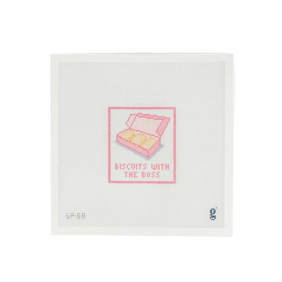 White needlepoint canvas with a pink rectangular design at center. Inside the rectangle is a pink cookie box partially opened to show shortbread cookies. The words "Biscuits with the Boss" are painted underneath.