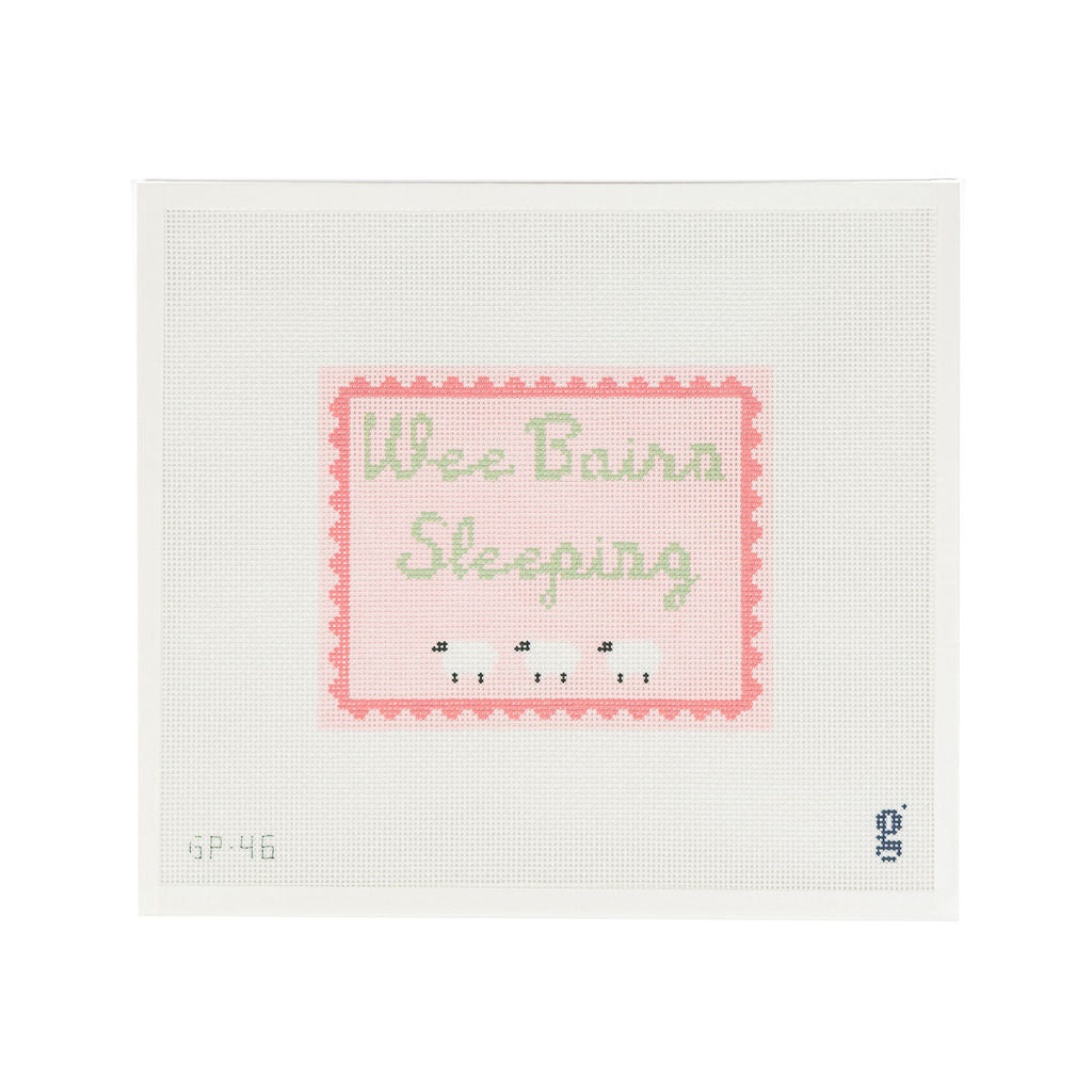 White needlepoint canvas with pink rectangular design featuring a darker pink scallop border and the words "Wee Bairn Sleeping" in green script font. Below which are 3 white sheep.