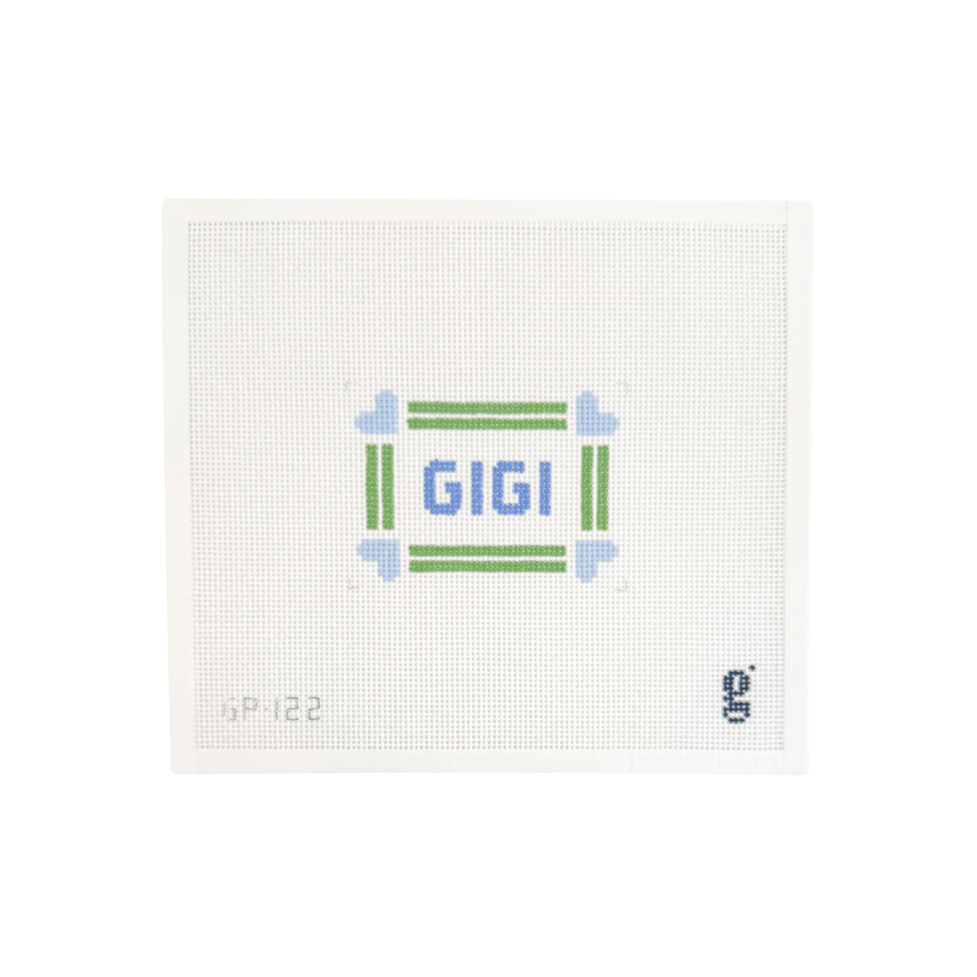 White needlepoint canvas with green striped border with light blue hearts at each corner. The word GIGI is at center in blue block text.