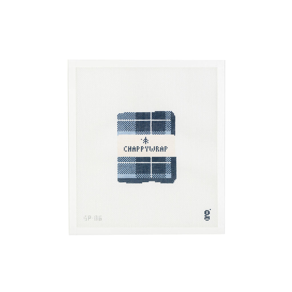 White needlepoint canvas featuring navy and light blue design of a folded plaid blanket with a packaging band and the brand "Chappywrap" in navy text