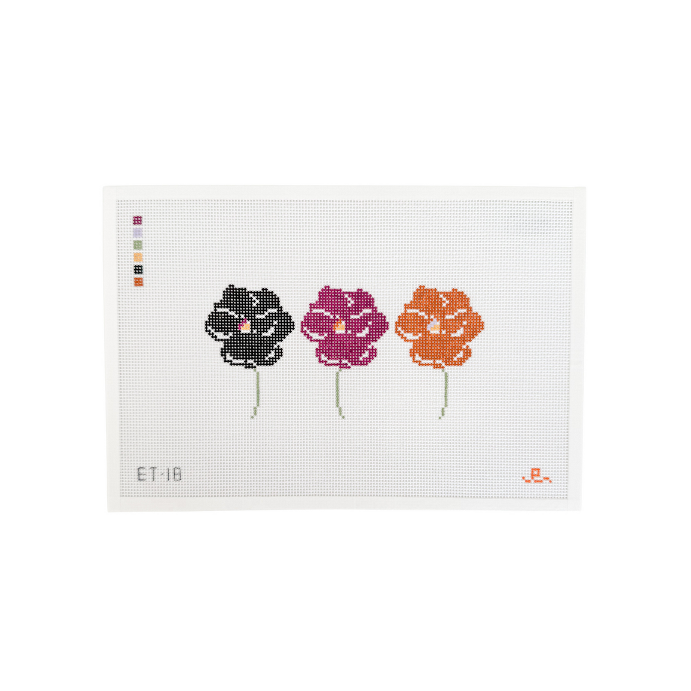 White rectangular needlepoint canvas with 3 pansy flowers at center: one black, one dark purple and one brown