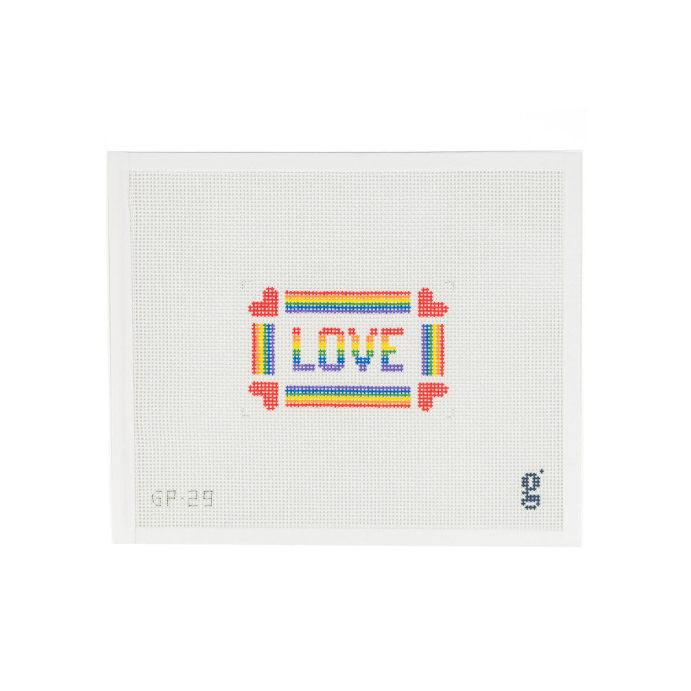 white needlepoint canvas with the word LOVE written in rainbow block text surrounded by rainbow striped border with a red heart at each corner 