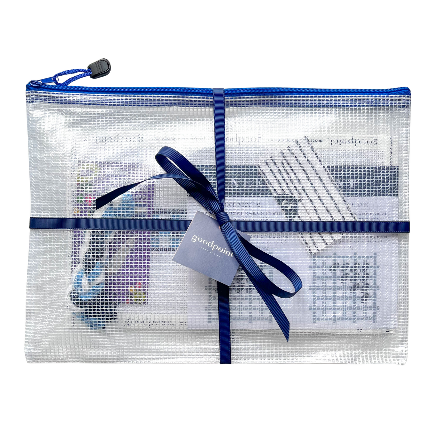 Needlepoint project bag filled with supplies is tied up with a navy grosgrain ribbon