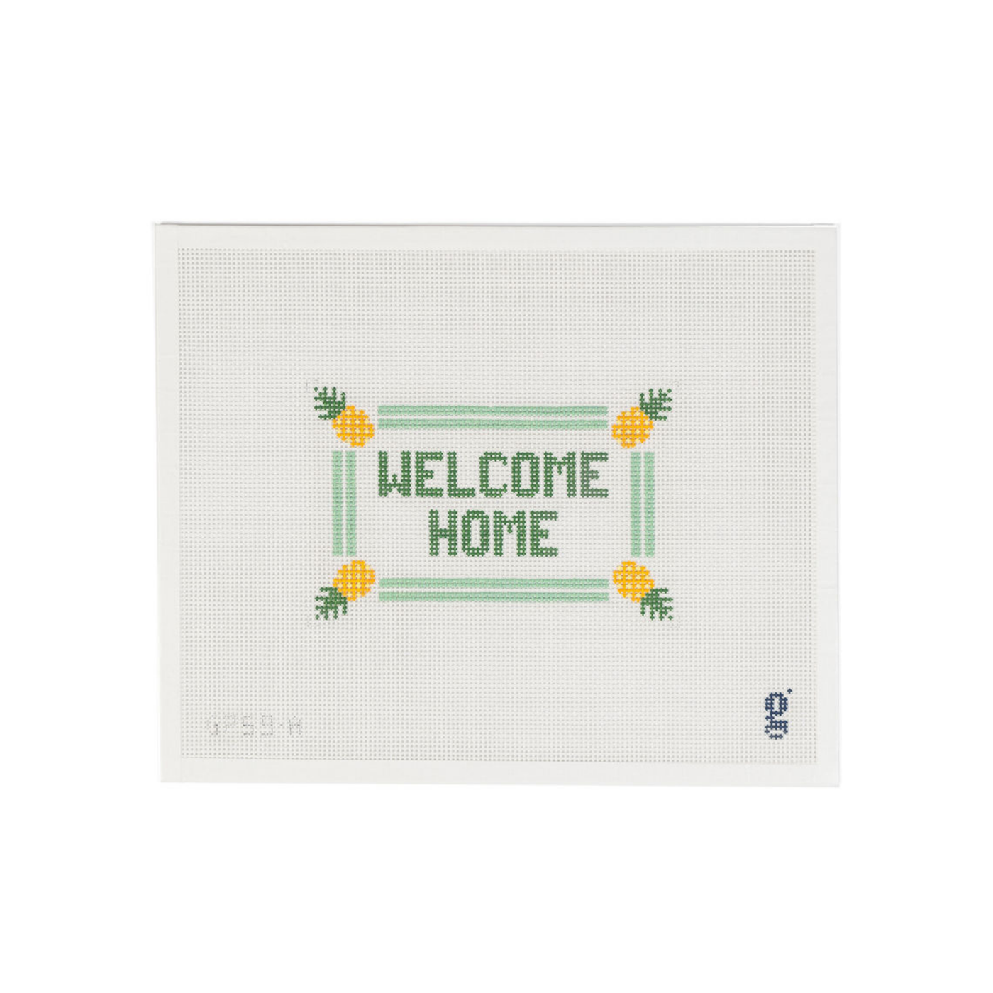 White needlepoint canvas with the words "WELCOME HOME" in green block text at center, surrounded by a mint double stripe border with yellow pineapples at each corner.