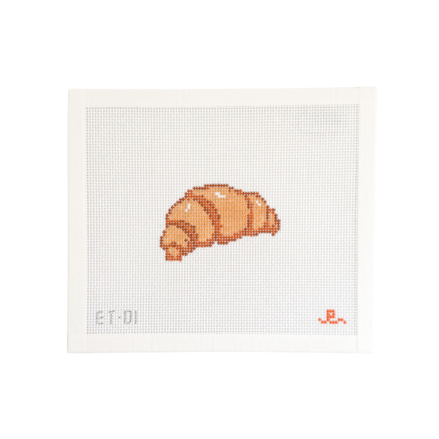 white needlepoint canvas with tan and brown croissant illustration at center