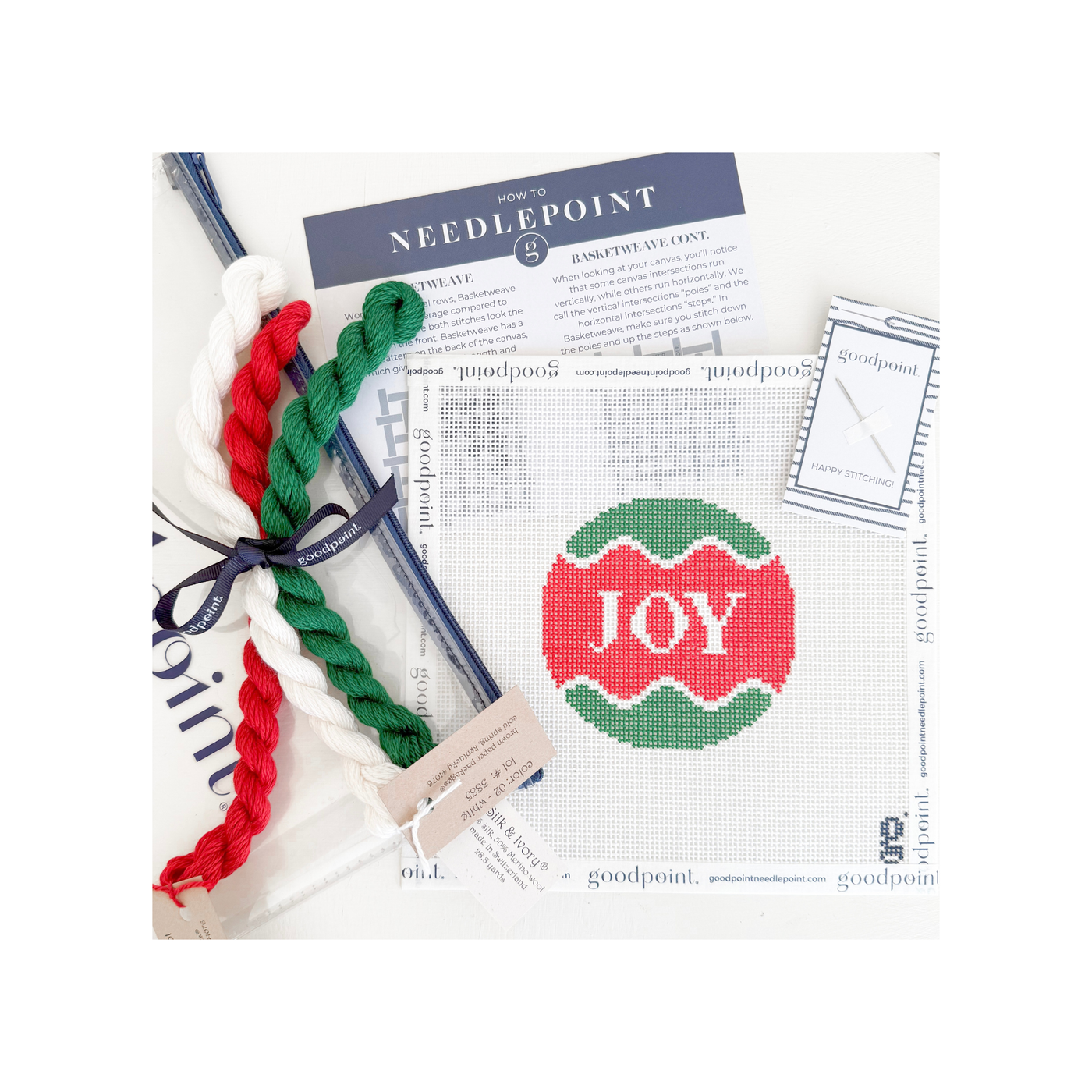 White, red and green round "JOY" needlepoint canvas with threads, clear project bag, and instruction postcard