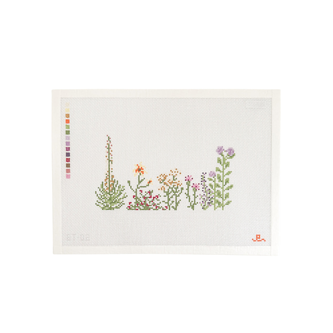 White needlepoint canvas with assorted wildflower illustrations at center